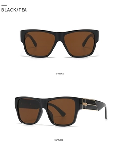 Detail view of black square sunglasses with tea lenses and golden metal temple decor