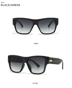 Close-up of black square sunglasses with grey gradient lenses and gold geometric metal joints