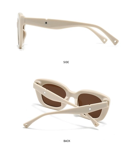 Detail view of cream oval sunglasses featuring silver arrow metal rivets and side temple