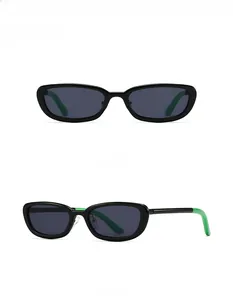 Detail of black oval sunglasses with gray lenses and stylish bright green temple tips