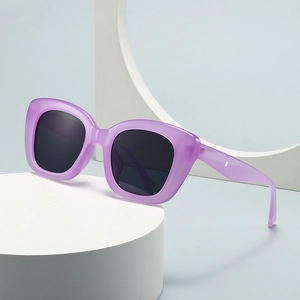 Modern vintage oval sunglasses with purple frame and dark lenses on a minimalist pedestal