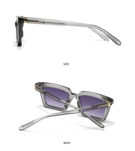 Detalle de gafas de sol cuadradas con lentes degradadas violetas y adornos de metal dorado