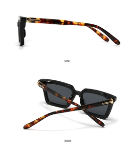 Detalle de gafas de sol negras vintage con bisagra de metal y patilla de carey clásica