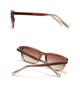 Detail view of amber resin sunglasses featuring brown gradient lenses and slim frame structure