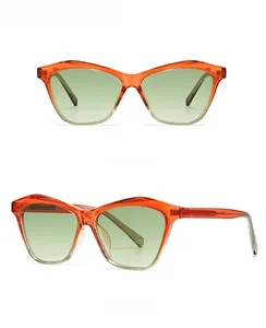 Detail of retro cat-eye sunglasses with orange frames and green gradient lenses