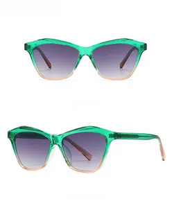Detail of green and peach cat-eye sunglasses with gradient purple to gray lenses