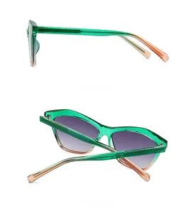 Detail view showing green and orange gradient resin frame and purple lenses on cat eye glasses