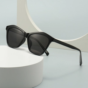 Modern oversized cat-eye sunglasses with thick black frames and dark polarized lenses