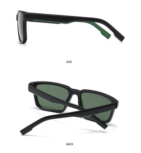 Dettaglio occhiali da sole sportivi con montatura rettangolare nera e accenti verde neon