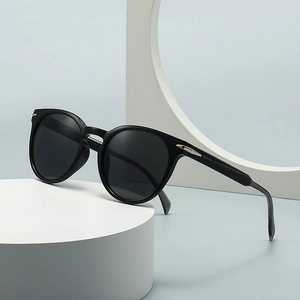 Classic round blue light blocking sunglasses with black frame and silver arrow details