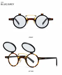 Detail view of round tortoise shell flip-up sunglasses with gold bridge and grey lenses