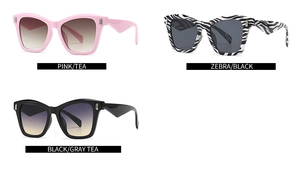 Close-up of oversized cat-eye metal sunglasses in pink, zebra and black color options
