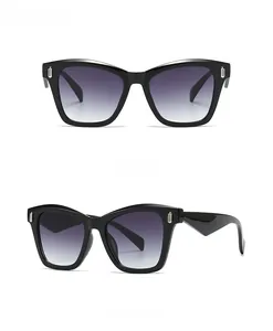 Front and 45-degree views of oversized black square sunglasses with grey gradient lenses