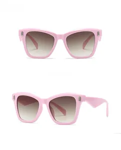 Detailed front and side views of pink cat-eye sunglasses with brown gradient lenses