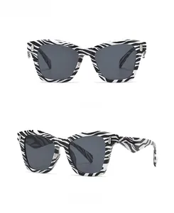 Front and side view of oversized zebra pattern sunglasses with dark grey lenses