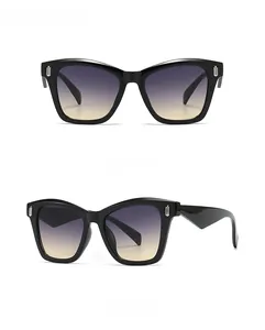 Macro detail of oversized metal sunglasses with gradient lenses and silver U-shaped accents