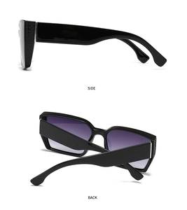 Detail view of wide black sunglass temples with clover hinges and gradient lenses