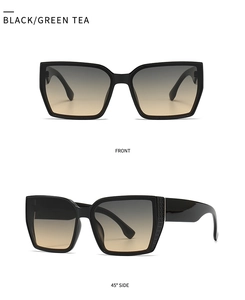 Detail view of large square black frame sunglasses with gradient tea lenses and side texture