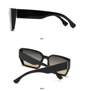 Detail view of large square sunglasses featuring clover embossed temples and gradient lenses