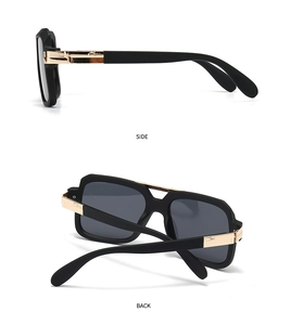 Detail view of black pilot sunglasses featuring gold metal accents and branding on temples