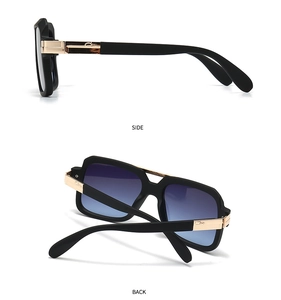 Detail view showing black frames, gold hinges and logo on classic aviator sunglasses