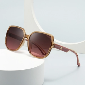 Modern square oversized sunglasses with brown transparent frames and red gradient lenses