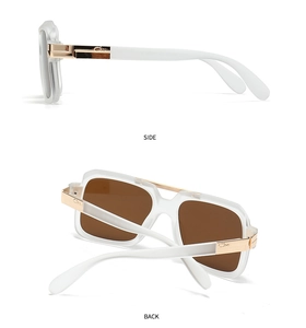 Detail view of white frosted aviator frames with gold metal hinges and brown lenses