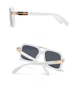 Detailed side and back view of white oversized pilot sunglasses with gold metal hinges