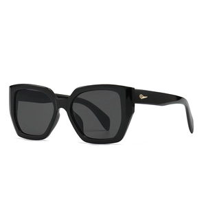 Modern polygon oversized black sunglasses with dark lenses and gold diamond temple accents