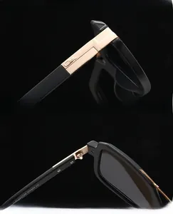 Detail view of matte black aviator sunglasses with gold metal temples and UV400 lenses