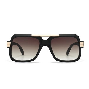 Classic pilot sunglasses featuring a thick black square frame and gold metal double bridge