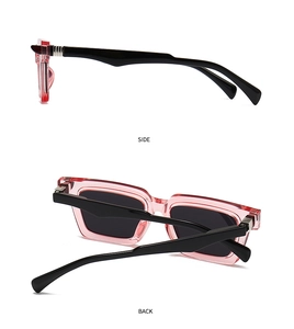 Detail view of pink transparent frame sunglasses with black temples and metal hinges