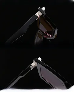 Close-up of durable silver metal hinges and UV protective lenses on black retro sunglasses