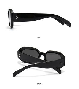 Detail view of oval sunglasses with black frames and silver triple-rivet hinge accents