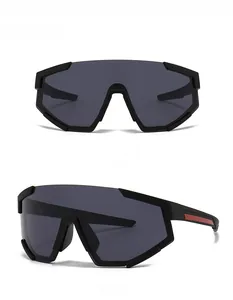 Detail view of oversized matte black sunglasses with red stripe and full black lenses
