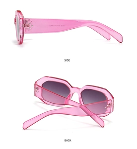 Detail view of pink transparent sunglasses with silver rivets and size specs on temple