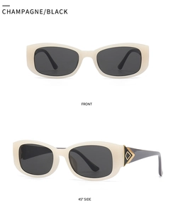 Detail view of champagne rectangle sunglasses with golden triangle accents and black lenses