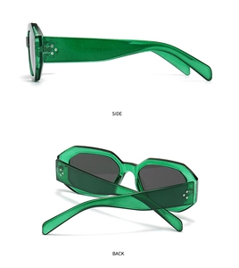 Detail view of oval green translucent frame sunglasses with silver rivet accents