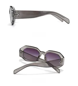 Detail view of transparent grey hexagonal sunglasses with purple gradient lenses