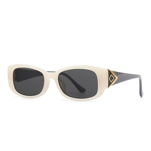Modern creamy white oval butterfly sunglasses with grey lenses and gold diamond metal trim
