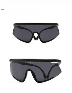 Close-up of black oversized cycling sunglasses with air vents and polarized gray lenses