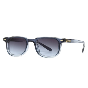 Square grey-blue transparent sunglasses with blue gradient lenses and gold arrow detail