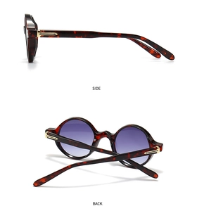 Détail des lunettes de soleil rondes en écaille avec verres dégradés violets et charnière dorée
