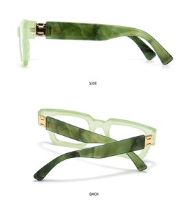 Detail of green ink-patterned frames with gold hinges and marble-textured temples