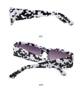 Side and back view of wide-frame cow print sunglasses with purple gradient lenses