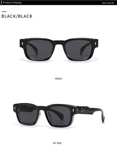 Detail view of black vintage sunglasses with golden arrow studs and side metal accents