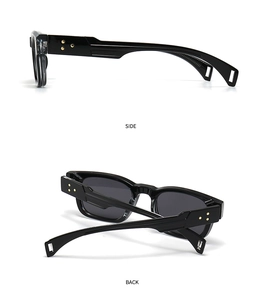 Detail view of black vintage sunglasses with golden triple star rivets on side and back