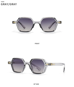 Detail view of transparent gray hexagonal sunglasses with gold arrow metal accents