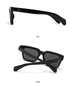 Detail view of black square sunglasses with three gold star studs on the temple hinges