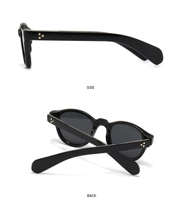 Detailansicht der schwarzen Vintage-Sonnenbrille mit goldenen floralen Scharniernieten